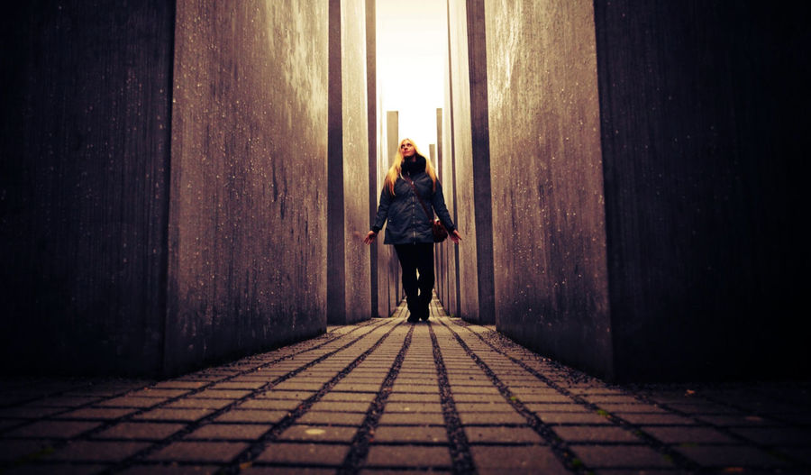 Full length of woman standing by railing