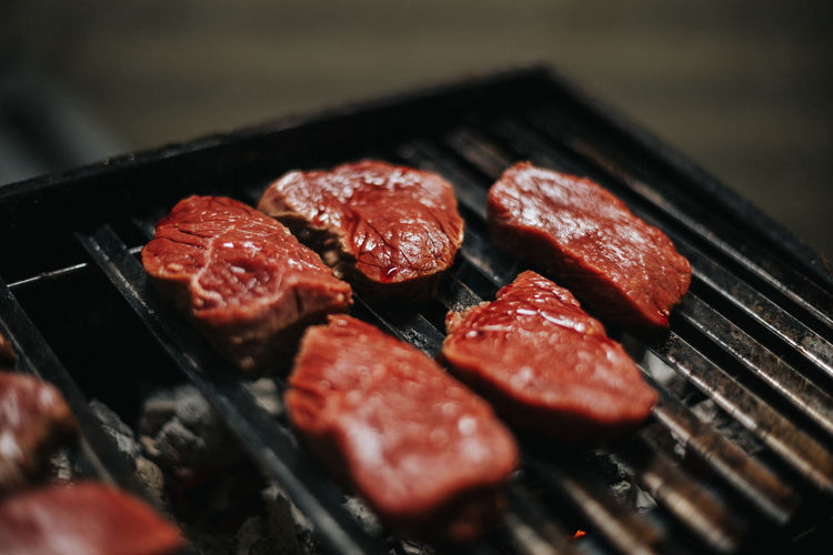 Close-up of raw meat on barbecue grill