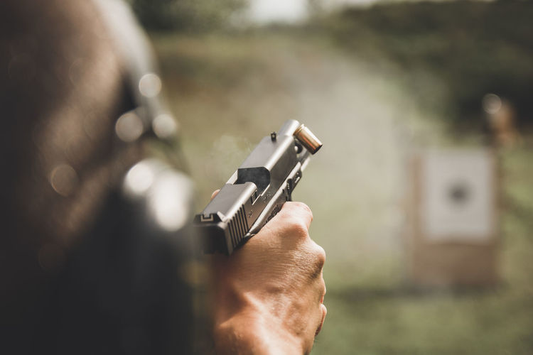 Close-up of person holding gun