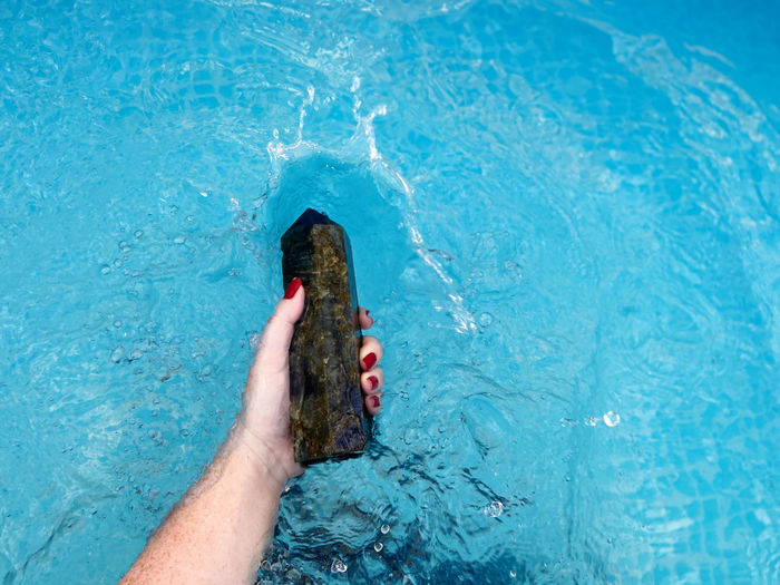 Low section of person swimming in pool