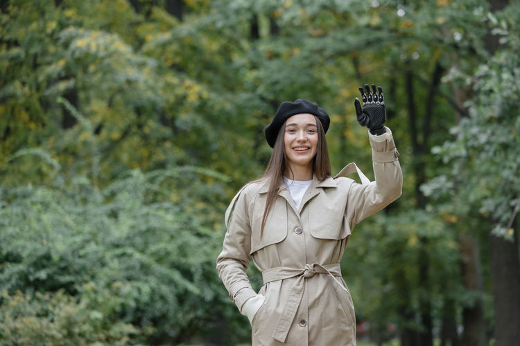 Portrait of young woman gesturing with prosthetic arms