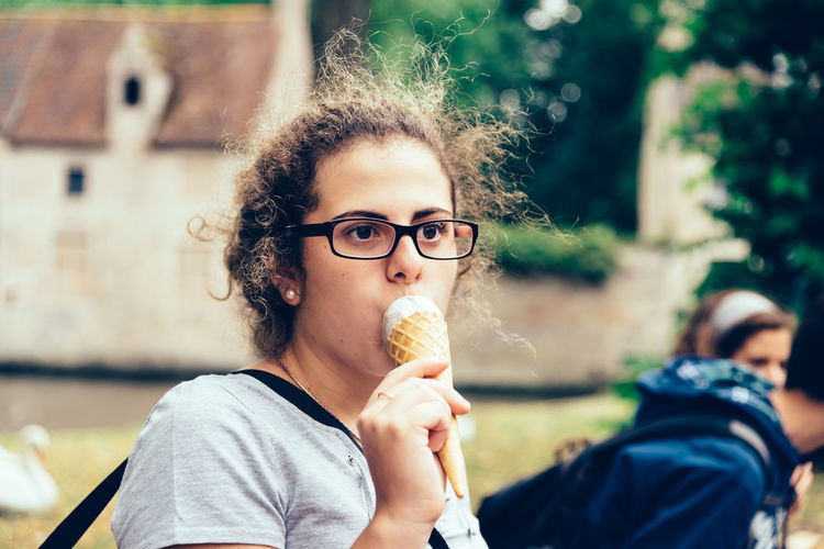 Close-up of woman looking away while eating ice cream