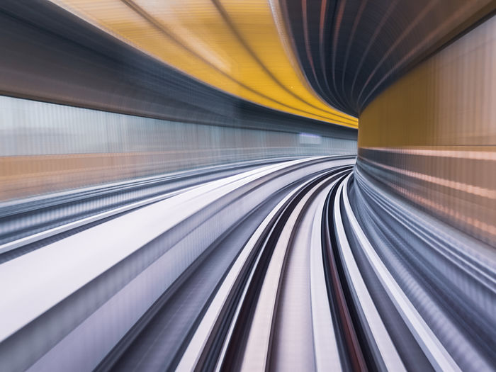 Blurred motion of train at railroad station