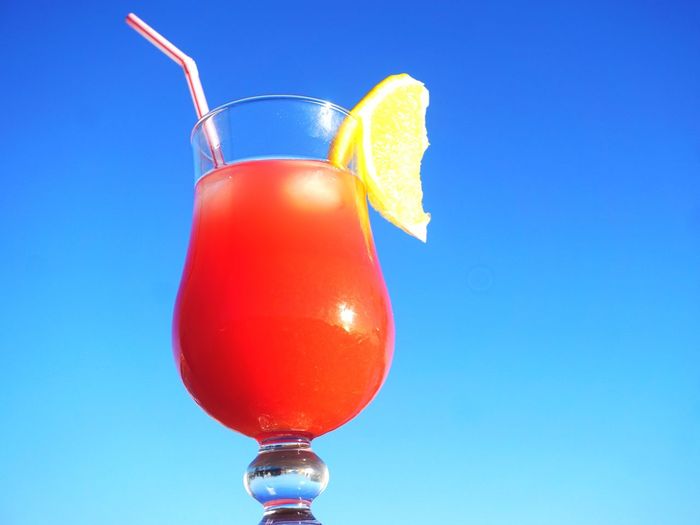 Low angle view of drink against clear blue sky