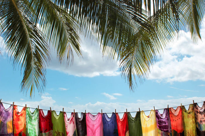 Laundry drying on rope against blue sky