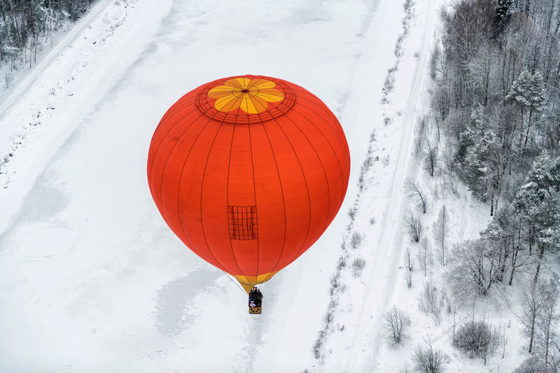 Aerial view of hot air balloon over snow landscape