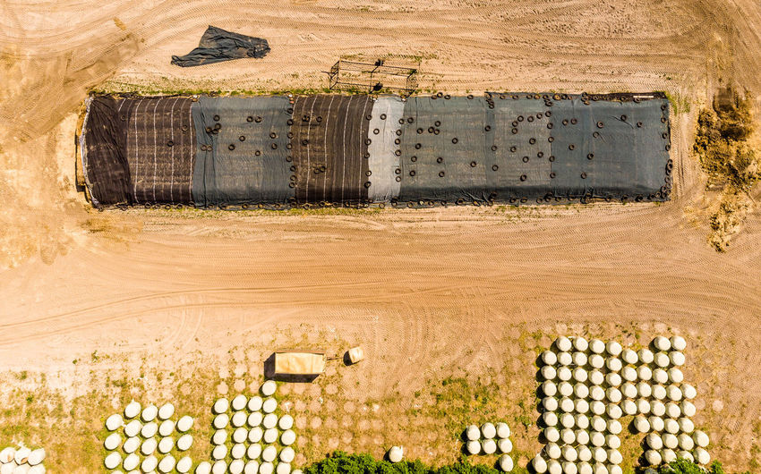 Aerial view of a farm camp, diagonal view of a large silage heap