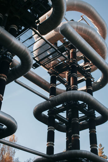 Low angle view of industry against sky