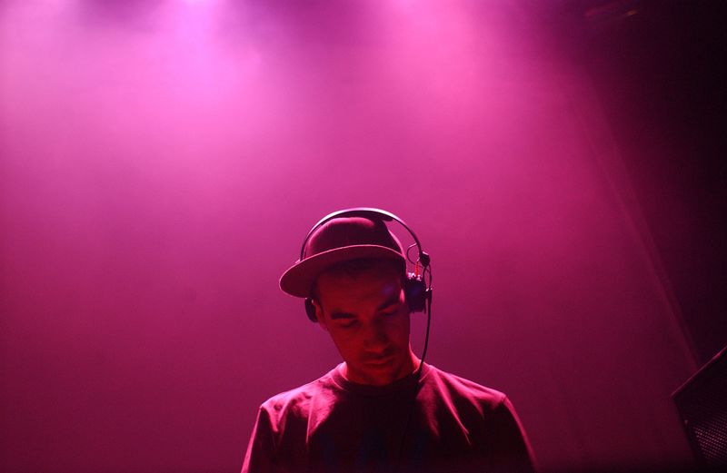 Man wearing headphones in illuminated nightclub
