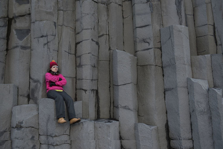 Woman sitting rock formation