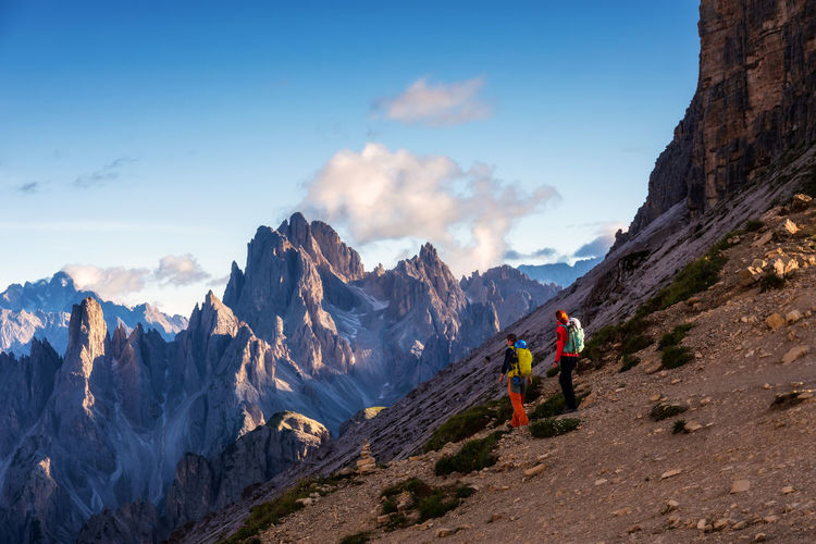 Hikers on the mountain path in the 3 cime natural park dolomites, italy