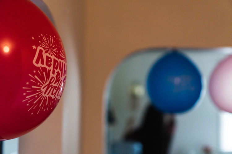 Close-up of balloons against wall at home