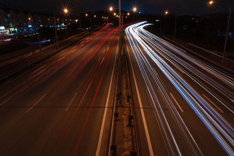 High angle view of light trails on highway at night