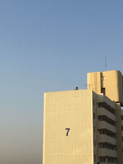 Number 7 on building against clear blue sky