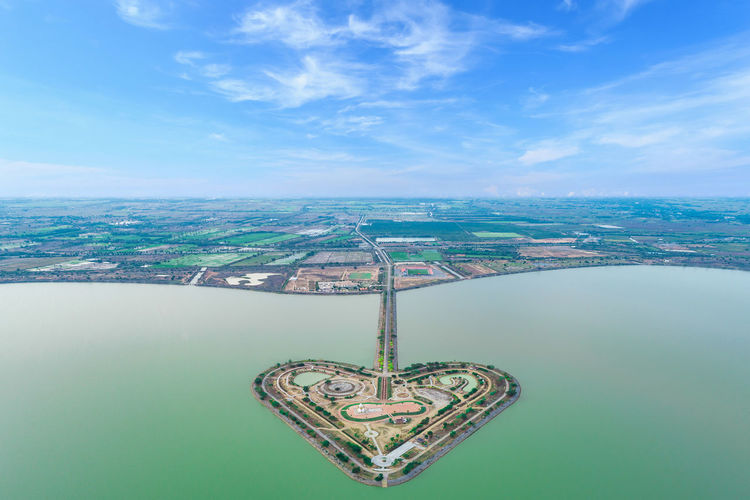 Aerial view of heart shaped island against sky