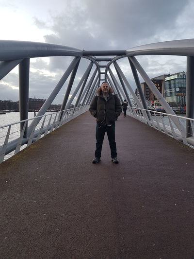 Full length of man standing on footbridge