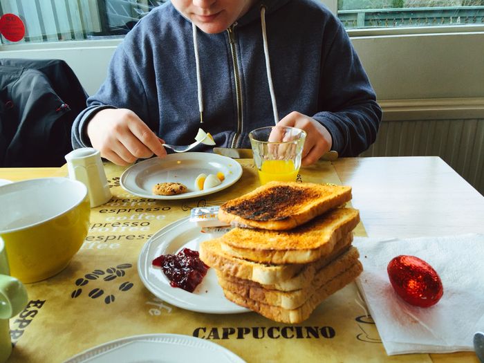 Midsection of boy having breakfast