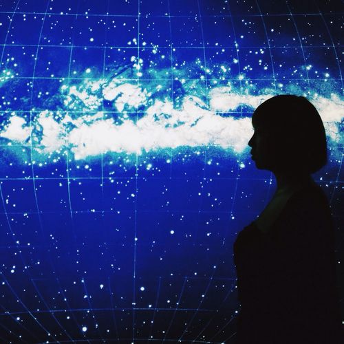 Woman in amusement park at night