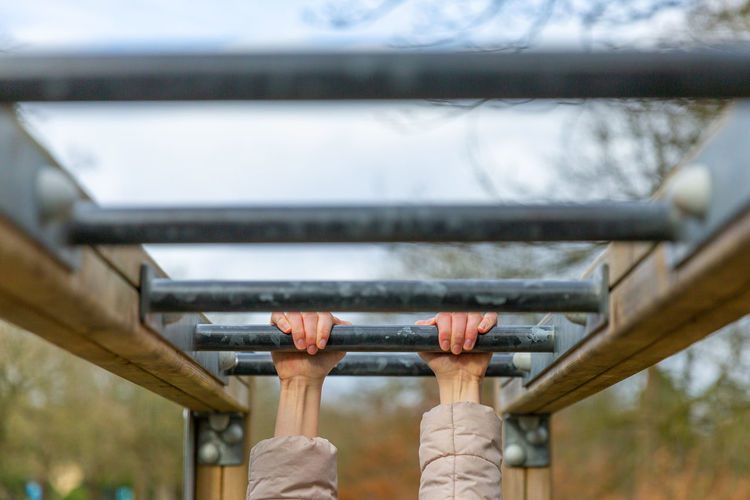 Close-up of people on railing