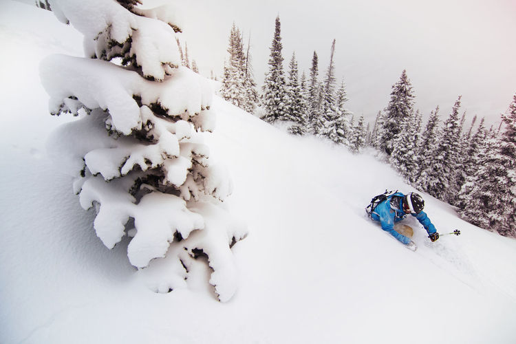 Man skiing on snow covered mountain