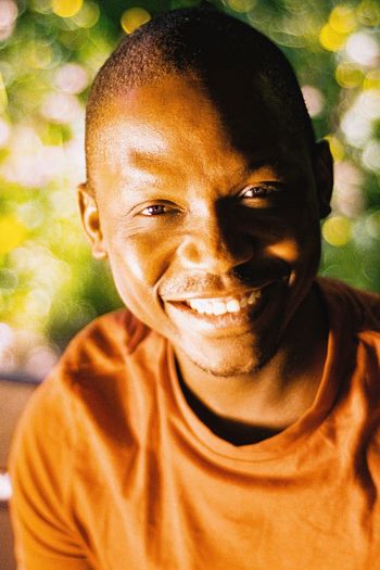 Close-up portrait of a smiling man from ghana