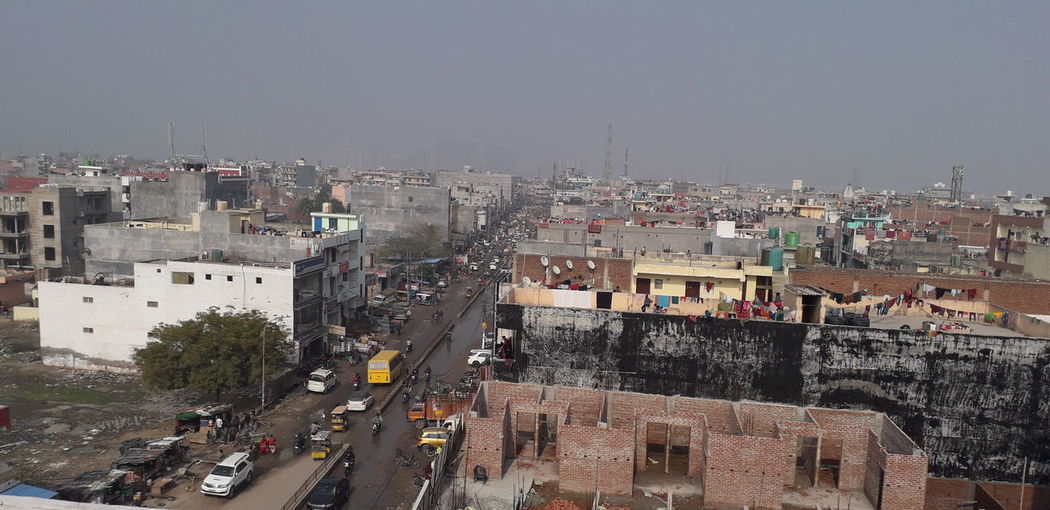 High angle view of vehicles on road amidst buildings in city