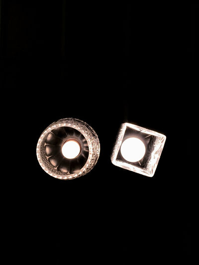 Close-up of illuminated lamp against black background