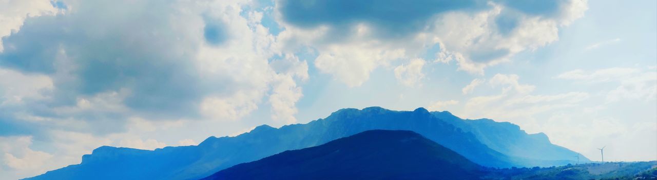 Low angle view of mountain range against sky