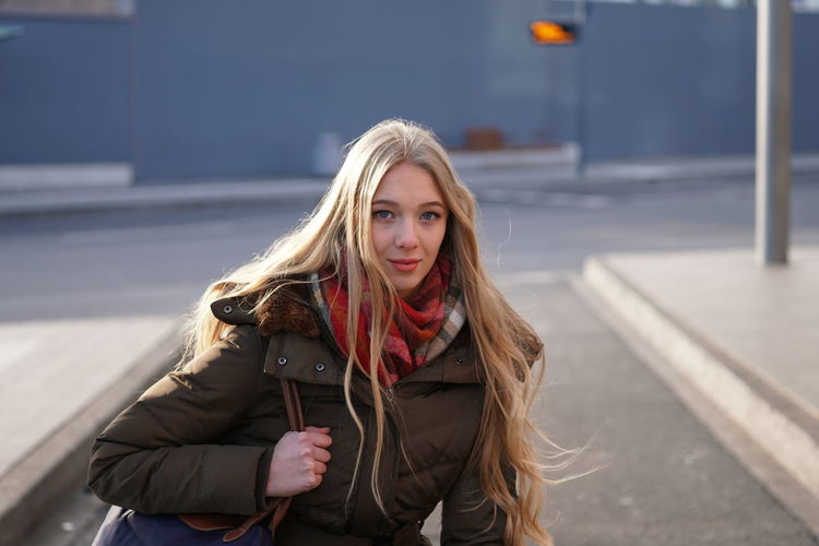 Portrait of beautiful young woman standing outdoors