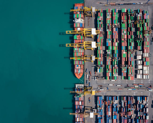 Commercial container shipping port in sea aerial top view
