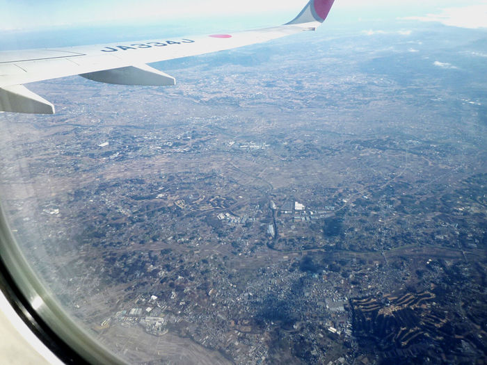 Aerial view of cityscape seen through airplane window