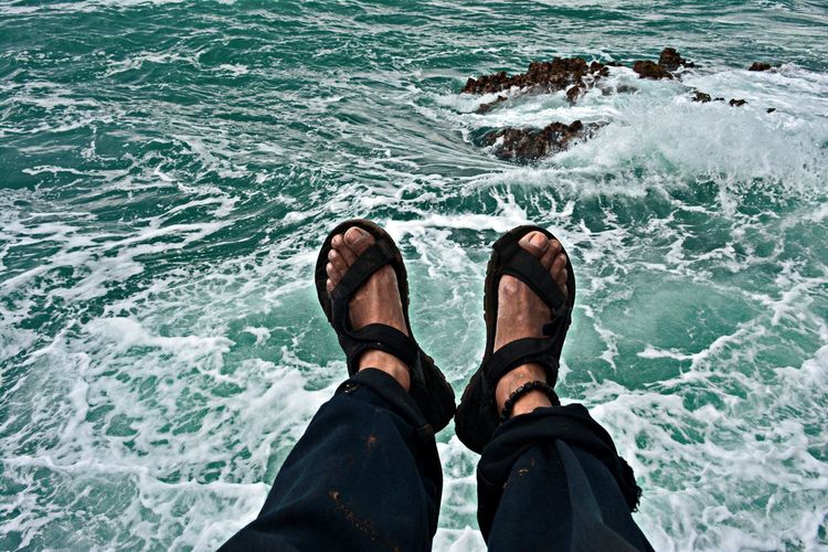 Low section of man against sea