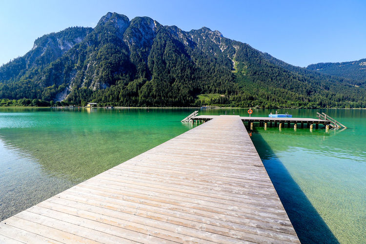 Scenic view of swimming pool by lake against sky