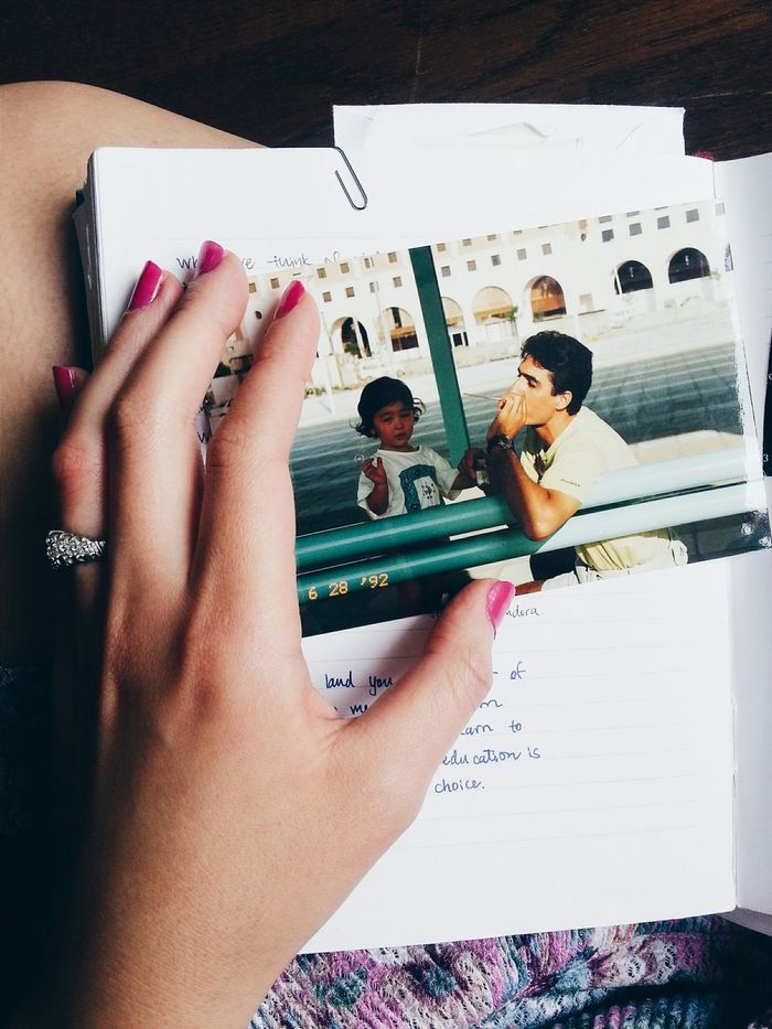 Cropped image of woman touching photograph