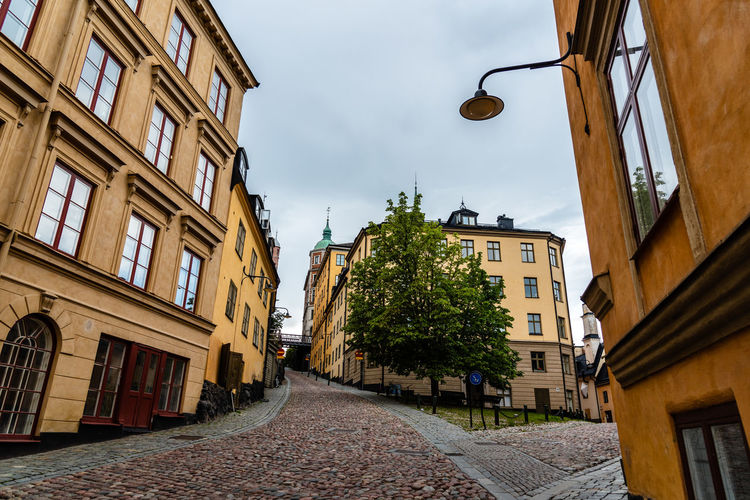 Picturesque cobblestoned street with colorful houses in ugglan quarter in sodermalm, stockholm, sw