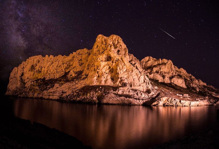 Low angle view of cliff at night