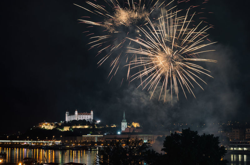 Low angle view of firework display at night
