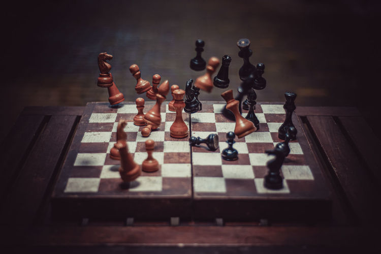 Falling chess pieces on the chessboard