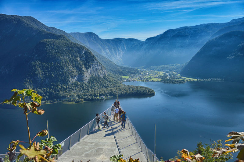 High angle view of people at observation point over lake against mountains