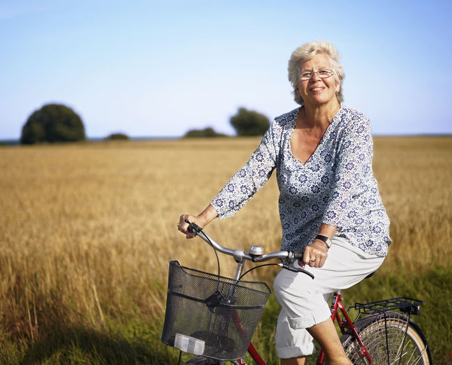 Older woman cycling and smiling