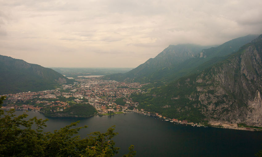 Scenic view of river by mountains against sky
