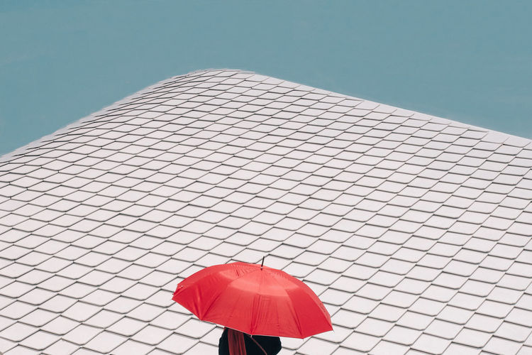 Red umbrella against blue sky