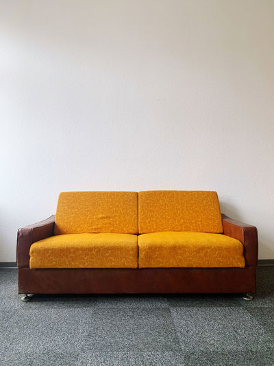 Close-up of sofa against wall at home
