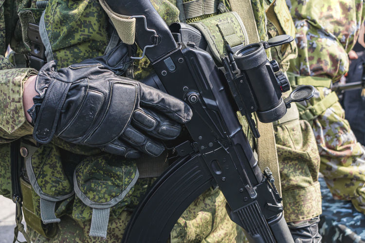Armed soldier holding a rifle with a scope