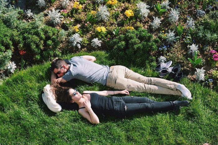 YOUNG COUPLE LYING ON FIELD