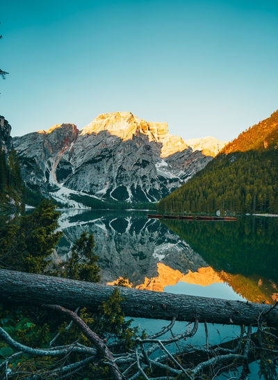 Scenic view of lake by mountains against sky during winter