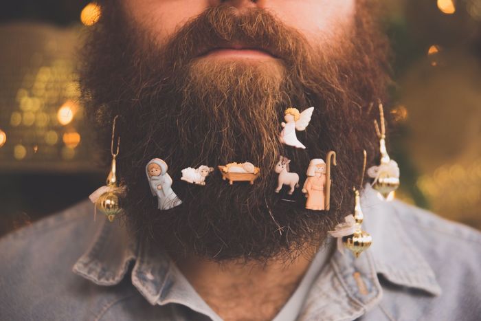 Christmas ornaments hanging from man's beards