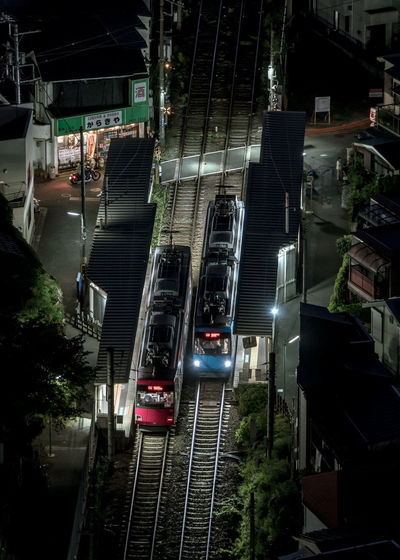 High angle view of train on street in city at night