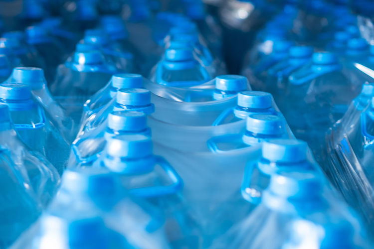 Packaged blue five-liter plastic bottles in the finished product warehouse