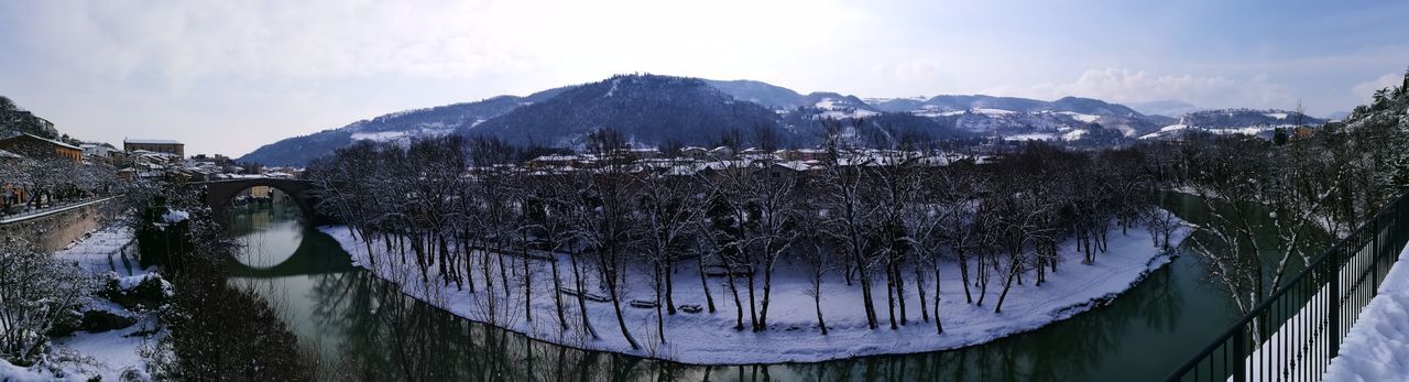 Panoramic view of frozen lake against sky